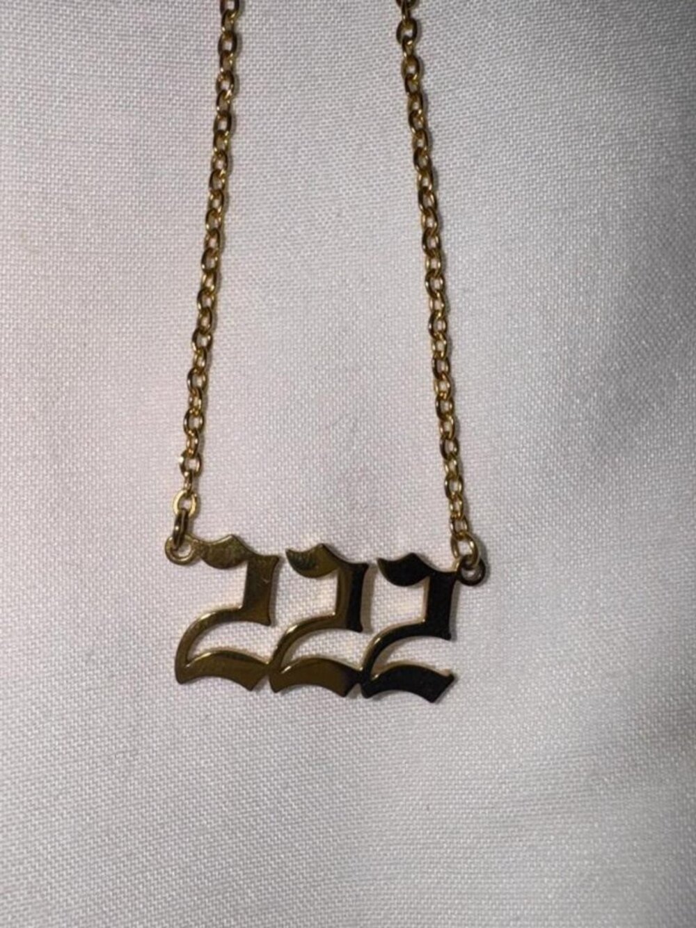 Gold necklace with angel number 222